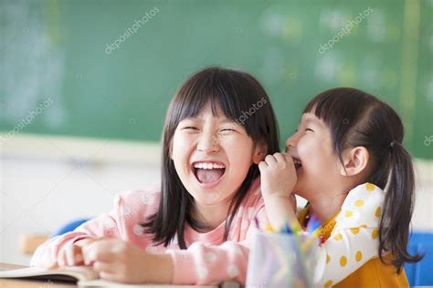 Laughing Little Girls Sharing Secrets In Class — Stock Photo © Tomwang