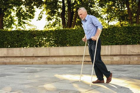 Elderly Disabled Man On Crutches In A Park Stock Image Image Of Active Exercise 34609951