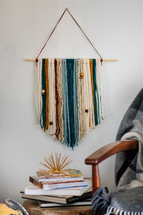 These decorative pieces of wall art will instantly add life to a plain wall, bringing the room together and giving it a soft, boho feel. How to Make an Easy DIY Yarn Wall Hanging | HGTV