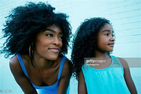 Portrait Of Black Mother And Daughter Looking Away Photo Getty Images