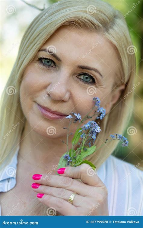 Close Up Portrait Of Face Of Well Groomed Blonde Outdoors Holding Of