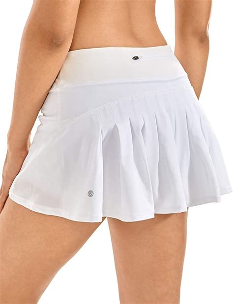 A Woman Wearing A White Tennis Skirt