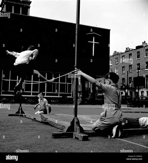 Historical 1950s School Physical Education Young Boy Jumping Over A