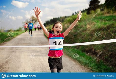 Small Girl Runner Crossing Finish Line In A Race Competition In Nature