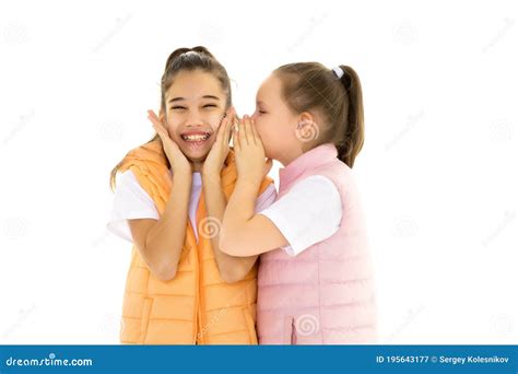 Two Cheerful Little Girls Share Secrets In Each Other S Ear Stock