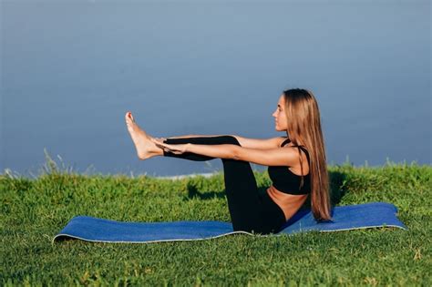 premium photo blonde longhair girl sitting in yoga pose outdoor