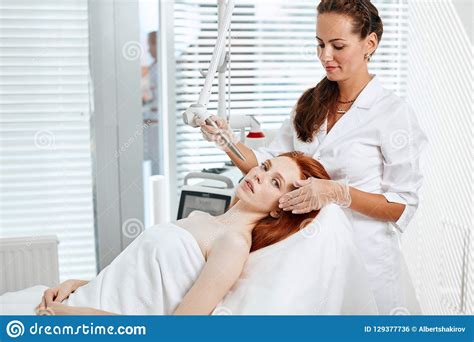 Woman Getting Laser Face Treatment In Medical Center Skin Rejuvenation