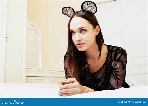 Young Pretty Brunette Woman Wearing Lace Mouse Ears Laying Stock Image