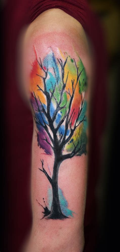 A Colorful Tree Tattoo On The Arm