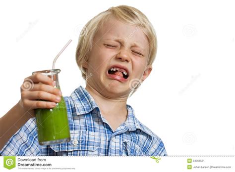 Boy Pulling Funny Face Holding Green Smoothie Stock Image