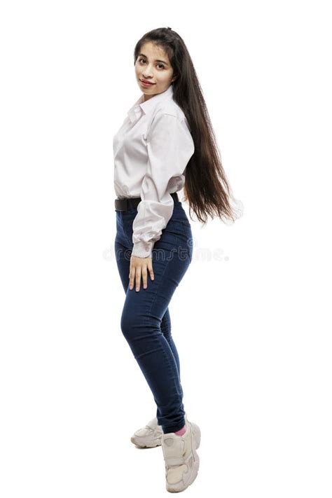 Laughing Young Girl In A White Shirt And Jeans Brunette With Long Hair