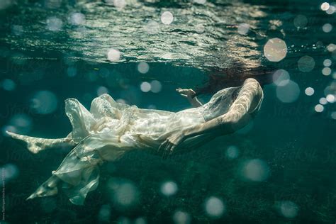 Underwater Photo Of Beautiful Woman Swimming In Boho Dress By Stocksy