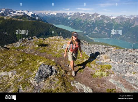 Woman Hiking Near The Top Of A Mountain Near Haines Alaska Stock Photo
