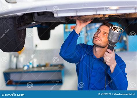 Mechanic Examining Under The Car With Torch Stock Photo Image Of