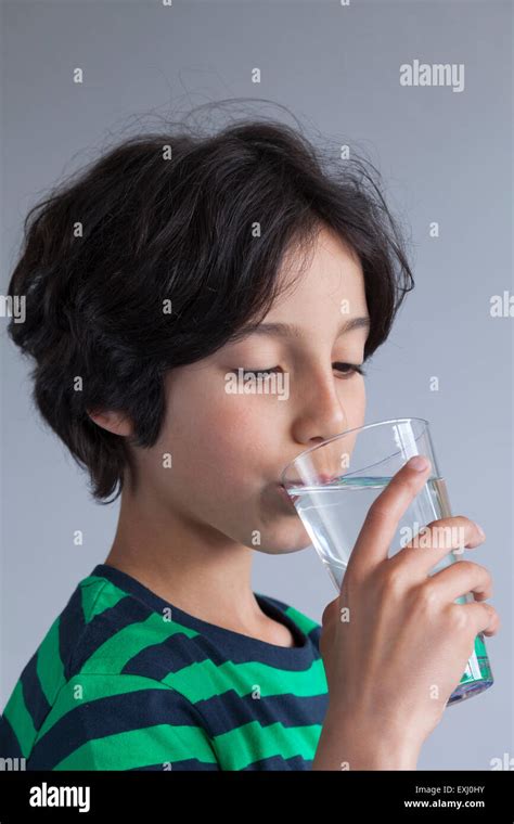 Teenage Boy Drinking A Glass Of Water Stock Photo Alamy