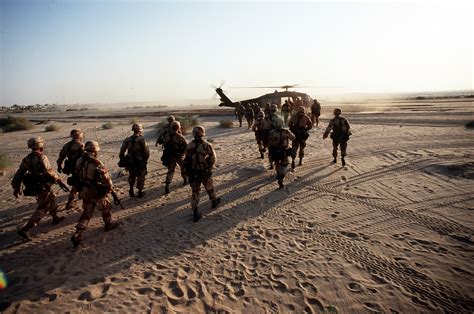 Soldiers Move Toward A Uh 60 Blackhawk Helicopter While The Squad Sent
