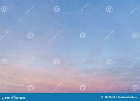 Partially Cloudy Pastel Pink And Purple Dusk Light With Blue Sky Stock