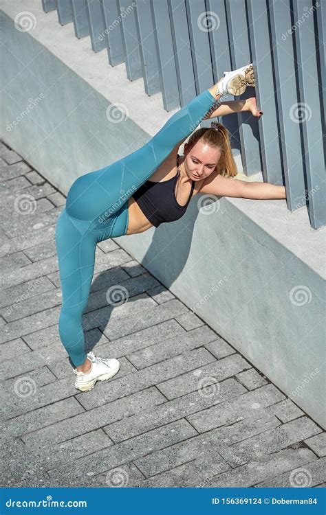 Beautiful Athletic Young Girl In Sportswear Doing Exercises For