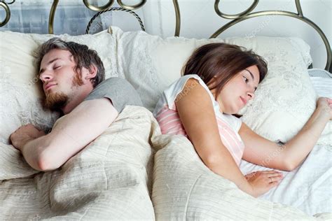 Husband And Wife Sleeping Together