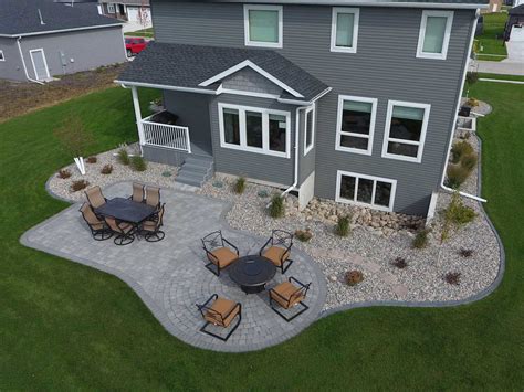 Gray Paver Patio With Edging Rocks And Plants Oasis Landscapes
