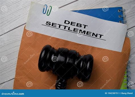 Debt Settlement Text With Document Brown Envelope And Gavel Isolated On