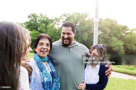 Adult Siblings Pose For Photo With Senior Mom Stock Photo Download