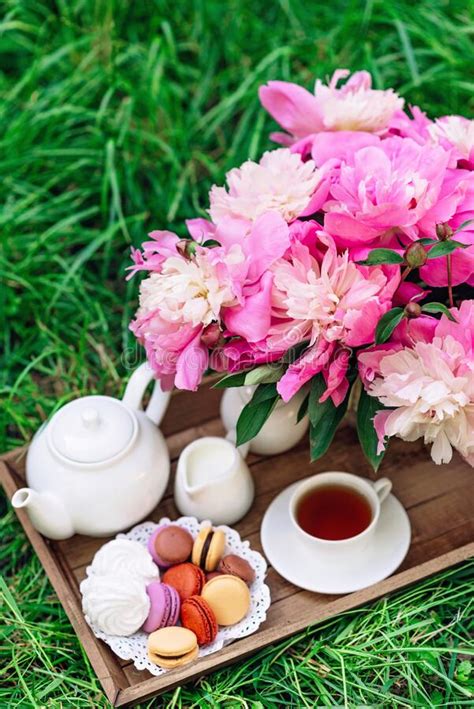 Cozy Breakfast Outdoors Peony Flower Vase Teapot And Cup Of Tea Macaroon Cake On A Wooden