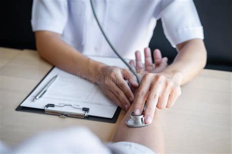 Doctor Using A Stethoscope Checking Patient With Examining Presenting