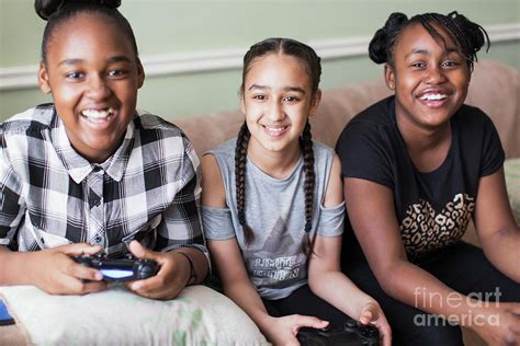 Portrait Smiling Tween Girl Friends Playing Video Game Photograph By