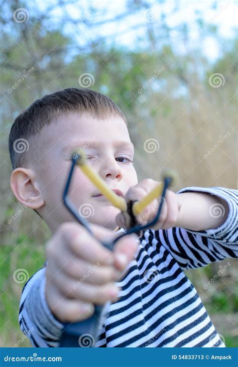 Young Boy Aiming Sling Shot At Camera Stock Image Image Of Outdoors