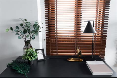 Stylish Working Corner Decorate With Artificial Plant In Glass Vase And