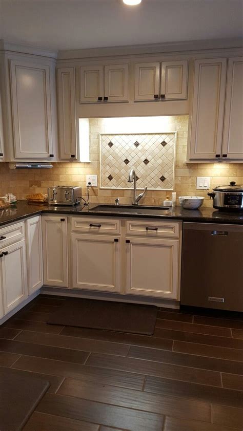 We went with thomasville (linden white) which was $150 a linear foot. Here is my finished kitchen. The cabinets are Thomasville ...