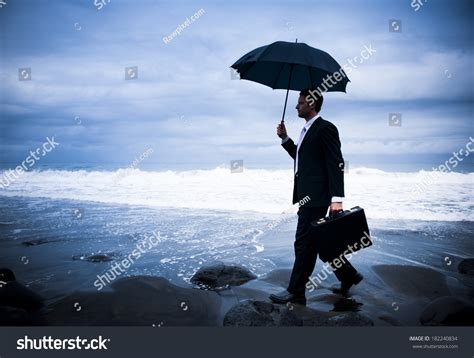 Businessman Umbrella On Stormy Beach Stock Photo 182240834 Shutterstock