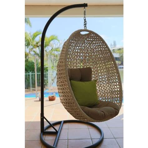 Lying back on a hanging egg chair in outdoor while breathing fresh air and alternatively. Hanging Egg Chair Out Door Furniture Brisbane Designer