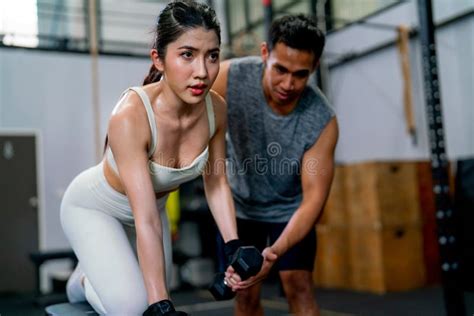 Asian Sport Woman Sit And Stay In Position Of Exercise With Hold Dumbbells And Look Forward Also