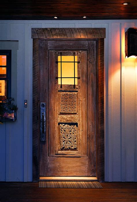 This Custom Front Entry With Antique Carved Panels Features A Grilled