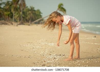 Girl On Beach Collecting Shells Stock Photo Shutterstock