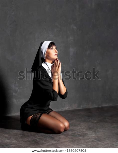 セクシーな尼僧が床に座って祈る写真素材1860207805 Shutterstock