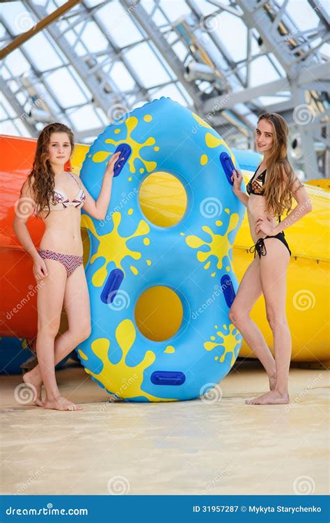 Smilng Women In Bikini Riding At The Water Slide In The Aqua Park Royalty Free Stock Photography