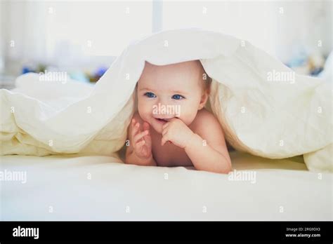 Cute Little Girl Playing On Bed Happy Kid Having Fun In Nursery Baby