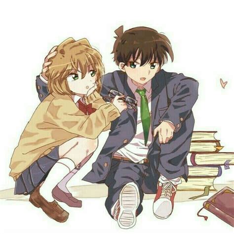 Two People Sitting Next To Each Other Near Books