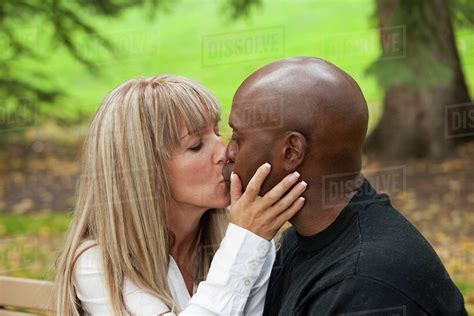 Interracial Couple Kissing In A Park; Edmonton, Alberta, Canada - Stock ...