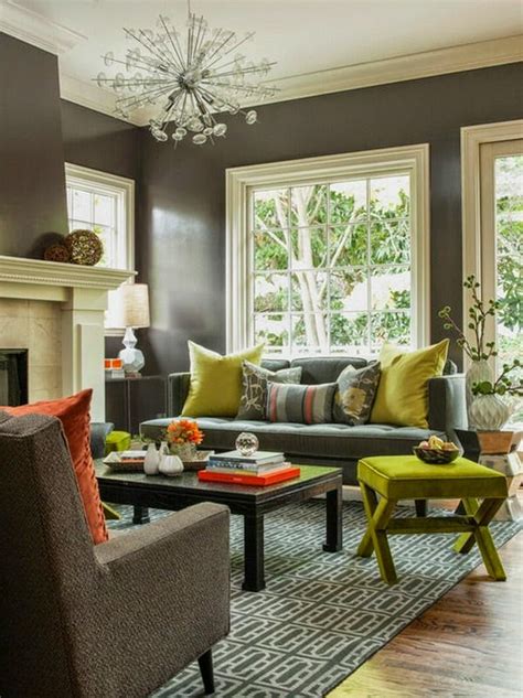 This formal living room is painted white and is brought to life by gold accents, seen in the light fixture, ottoman and artwork. 20 Comfortable living room color schemes and paint color ideas