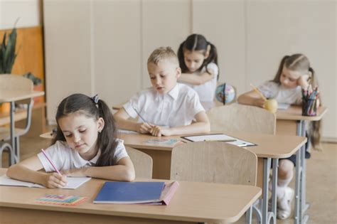 Kids Writing In Notebooks During Lessons Free Photo