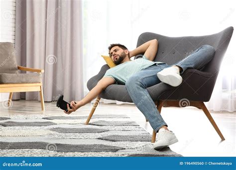 Lazy Man Playing Video Game While Lying On Sofa At Home Royalty Free Stock Image Cartoondealer