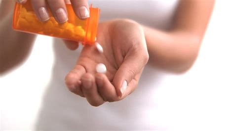 Close Up Of Woman Pouring Pills Into Her Hand Stock Footage Video