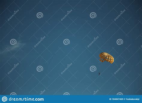 Yellow Parachute With A Man In The Sky Stock Image Image Of Glide