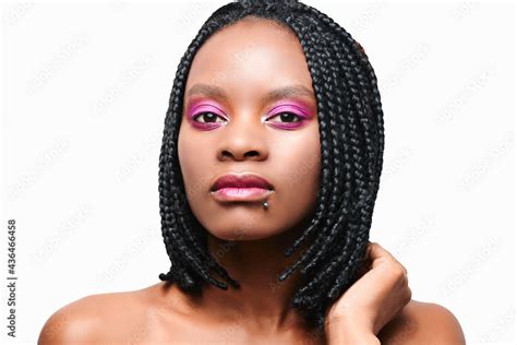 beauty portrait of an african american girl pink visage make up hairstyle braids dreadlocks