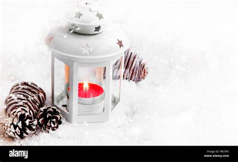 Magic Christmas Lantern With Red Burning Candle In The Snowfall Stock