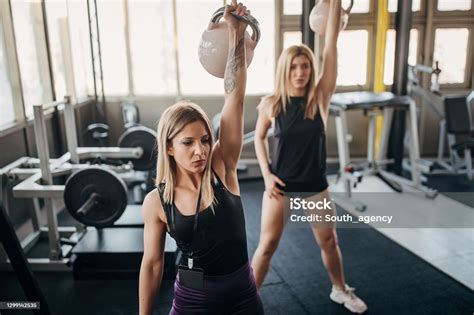 Female Personal Trainer And Her Female Trainee Exercise With